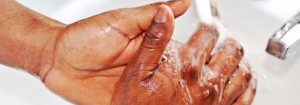 Washing hands under running water.