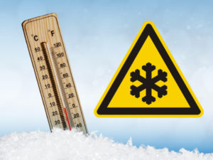 A thermometer showing minus twenty degrees Celsius and a triangle warning sign with a black snowflake in the centre.